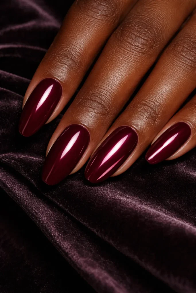 Burgundy manicure featuring a metallic chrome finish on the ring finger accent nail.