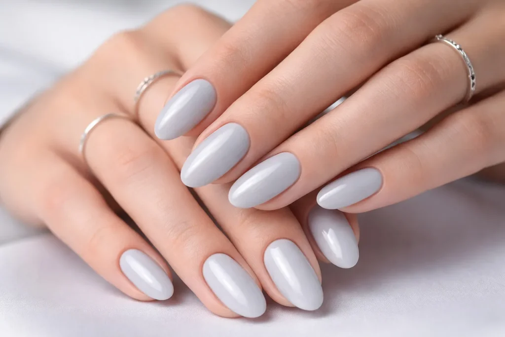 Modern light grey glossy nails with silver accessories