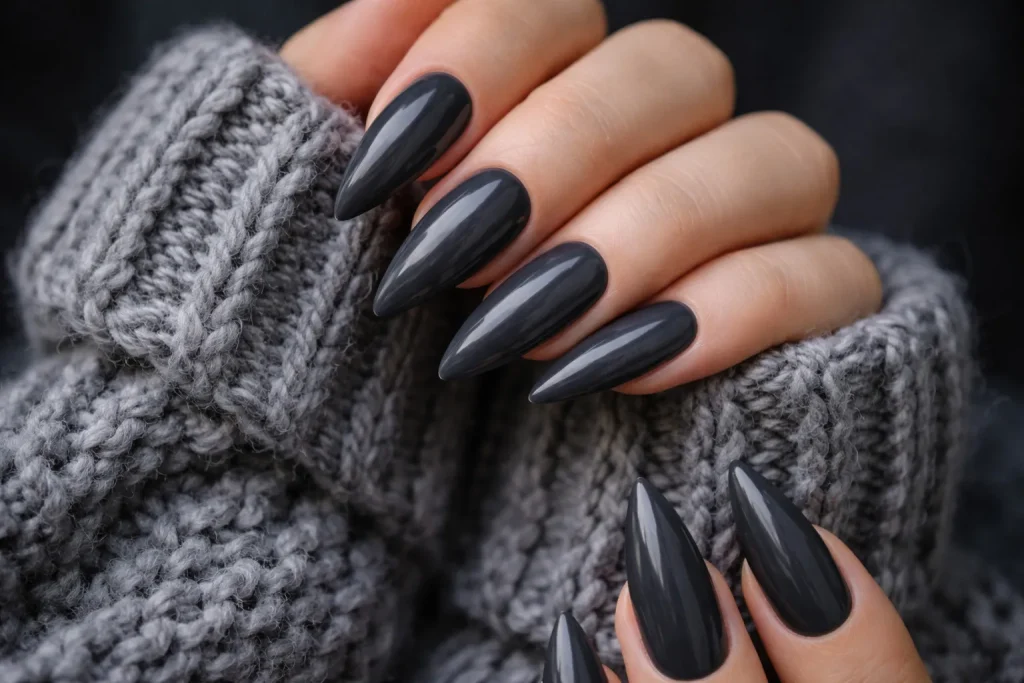 Dark charcoal grey stiletto nails paired with a chunky knit sweater.
