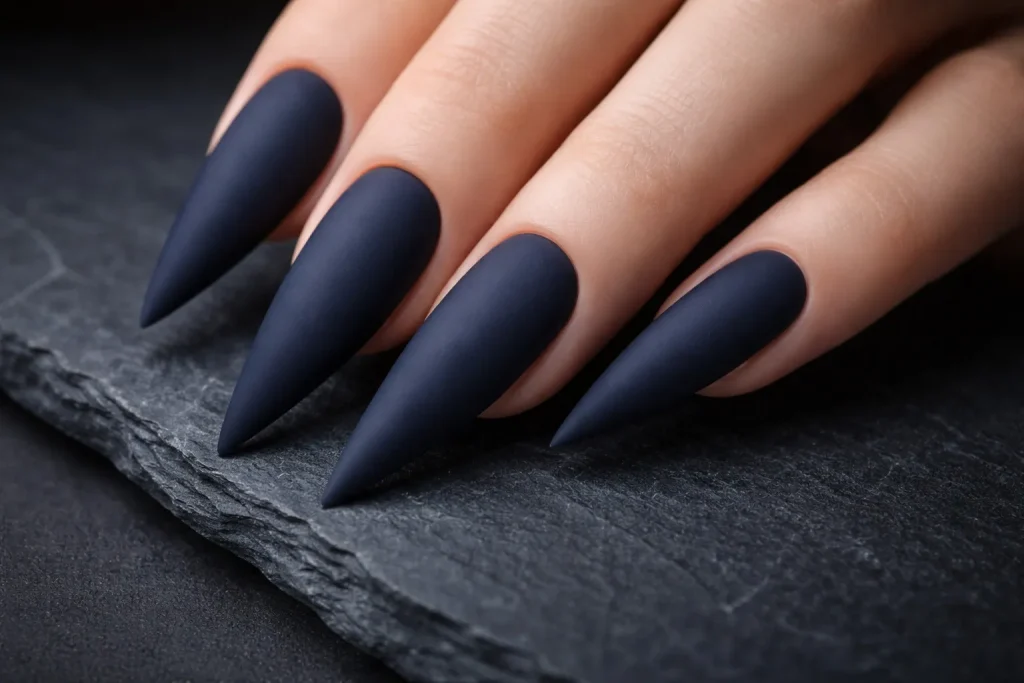 Matte navy blue stiletto nails with a velvety non-reflective finish