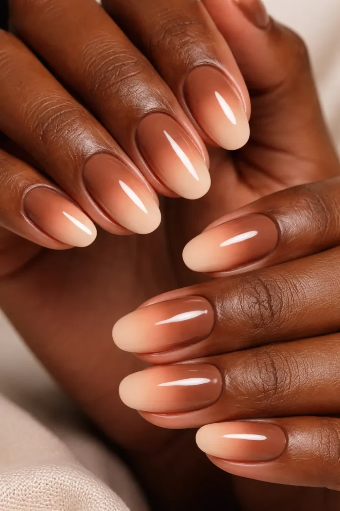 Brown to nude ombre gradient on short almond nails