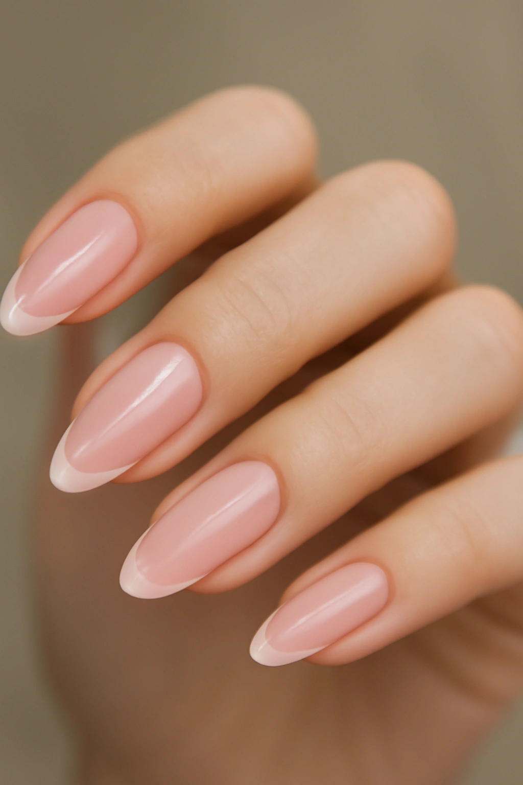 Almond nail with milky pink base and subtle French tip