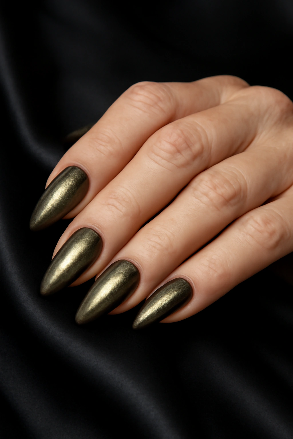 Cat eye nail shape with shimmering magnetic polish on mature hands