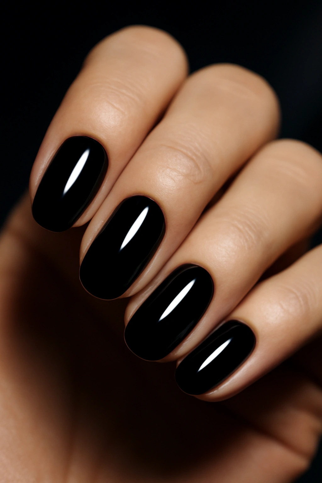 Bold glossy black nail polish with high shine finish