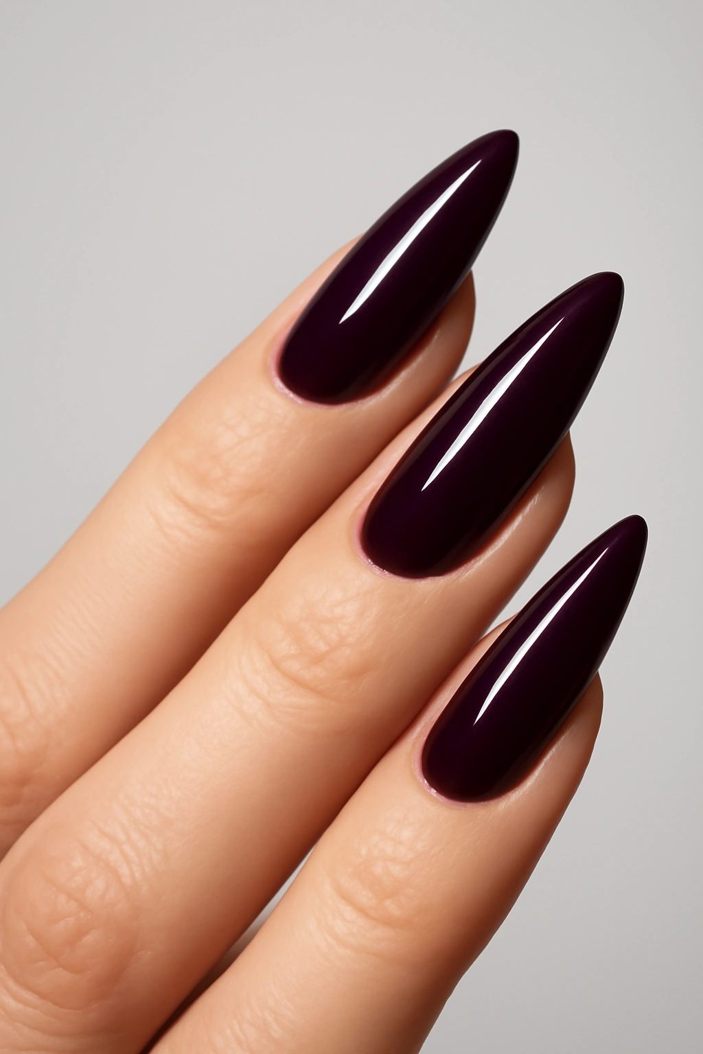 Side profile of high arch nail shape showing a sculpted apex on a mature hand