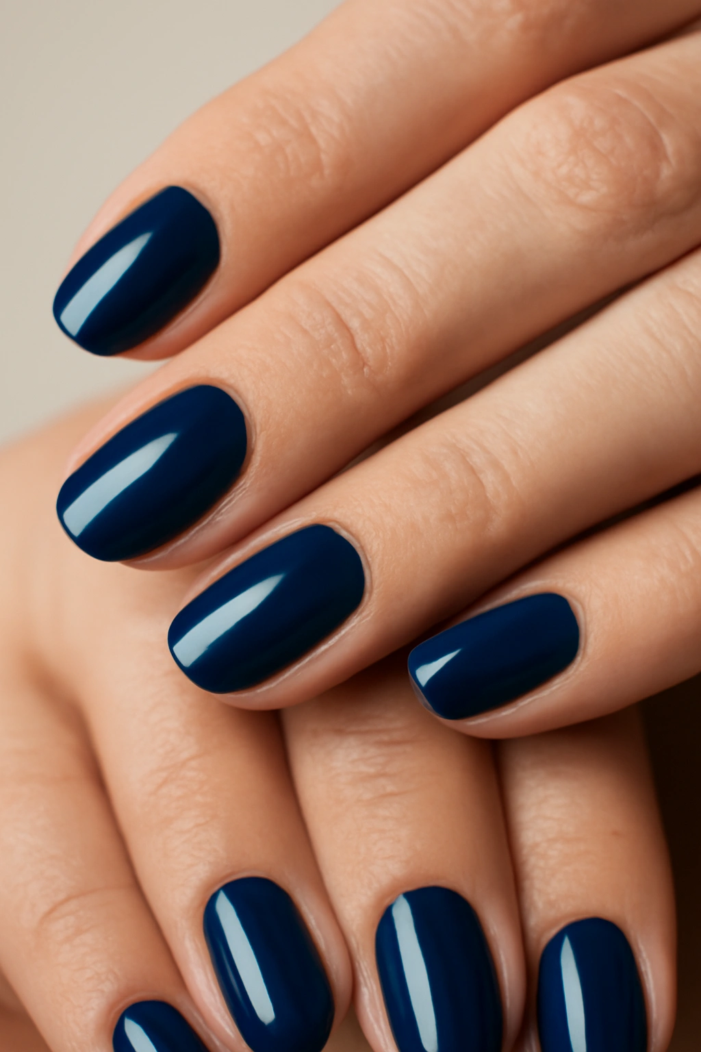 Close-up of hands with navy blue nails, deep elegant shade