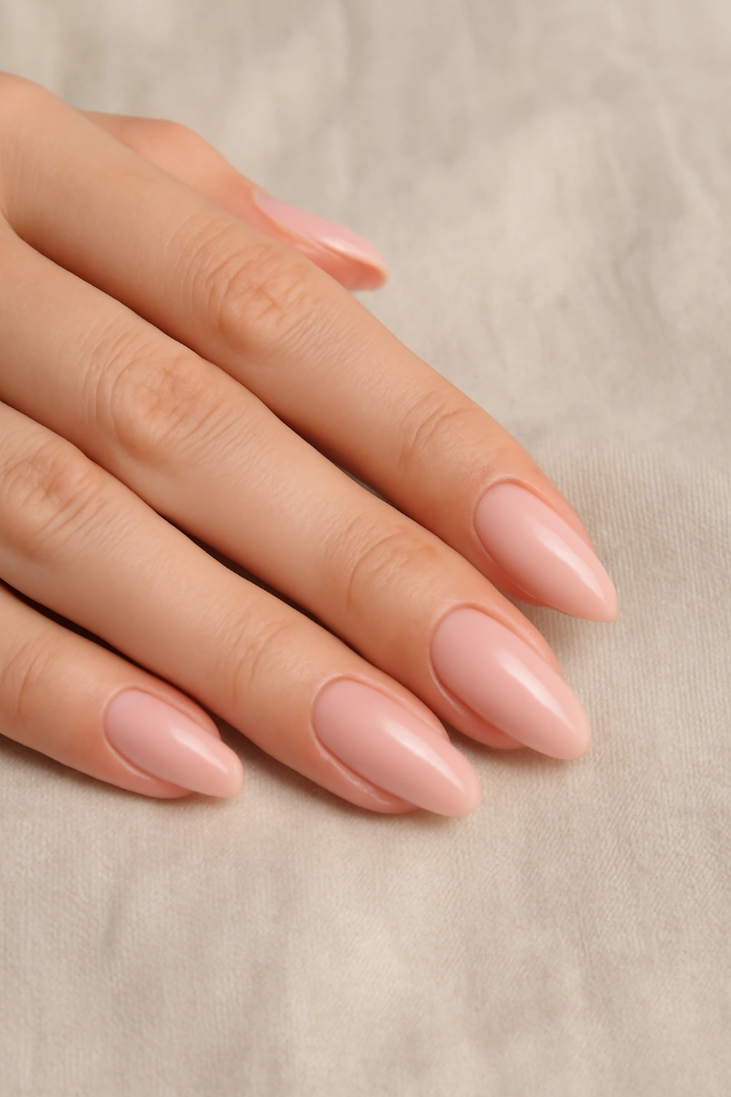 Minimalist soft pink and nude nail design on long oval nails
