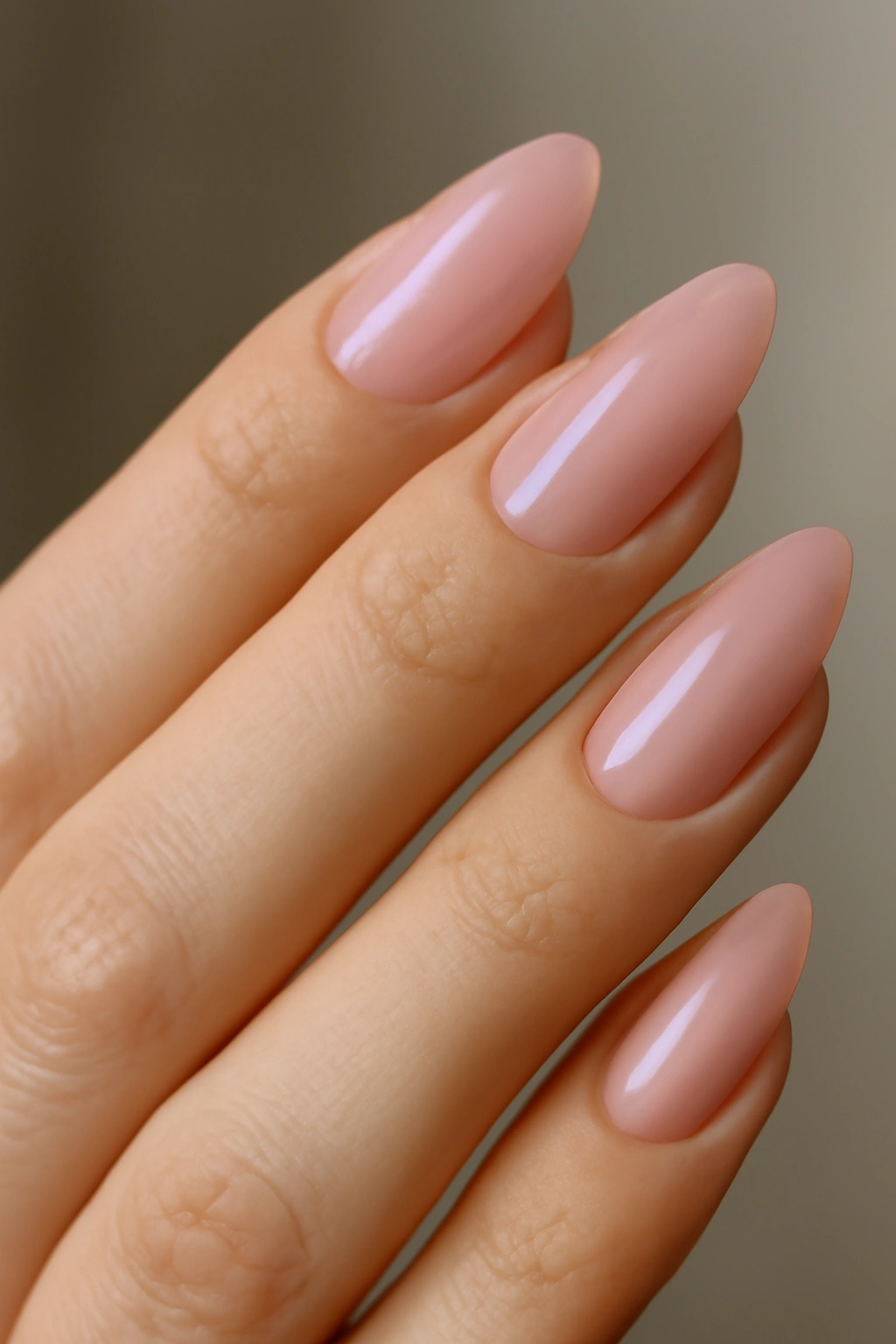 Almond nails with nude to pink ombre gradient on natural hand