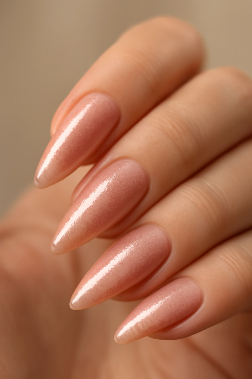 Close-up of rose gold shimmer pink almond nails