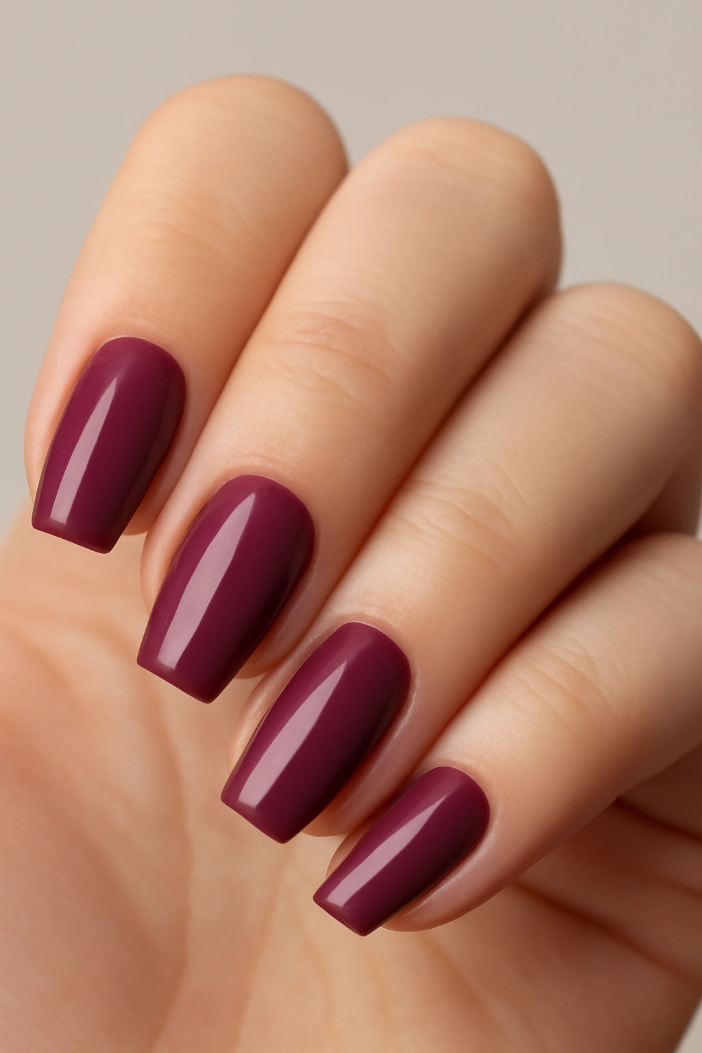 Tapered square nail shape with mauve polish on wider fingers.