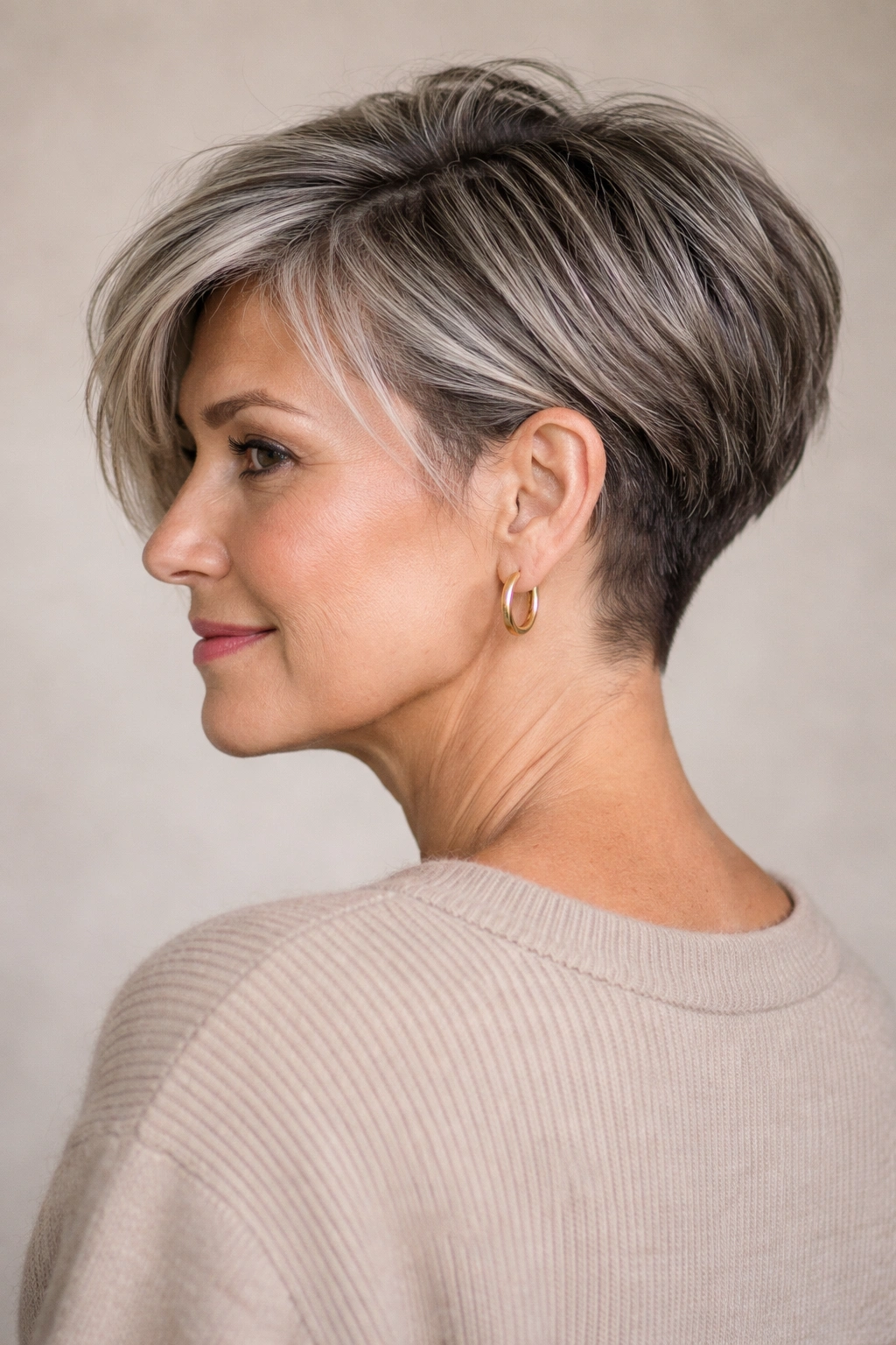 Older woman with undercut pixie bob showing hidden nape undercut